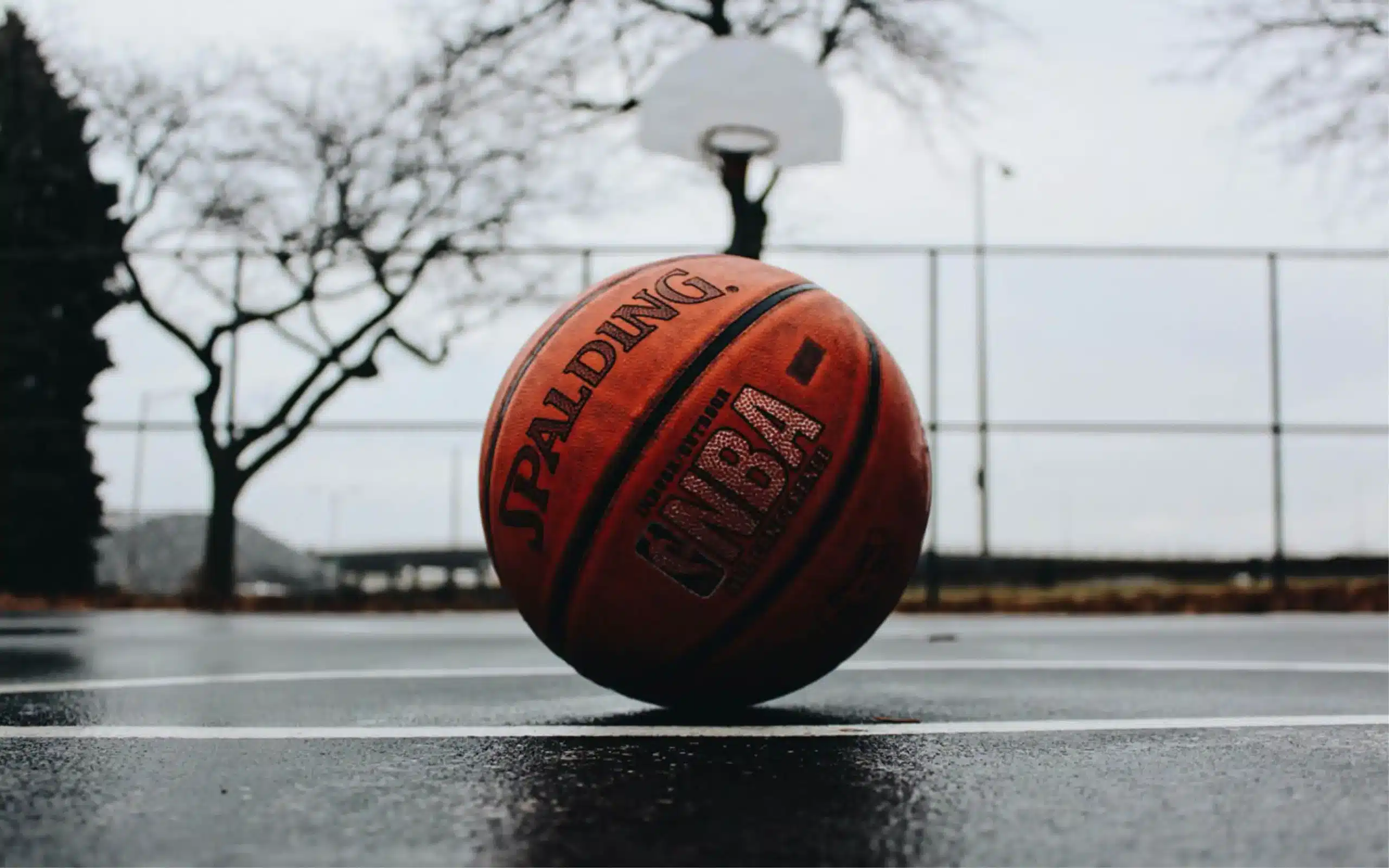 NBA basketball on basketball court in an urban setting